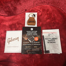 Gibson L-00 Original Vintage Sunburst acoustic guitar included accessories with warranty card, safety manual, and leather key