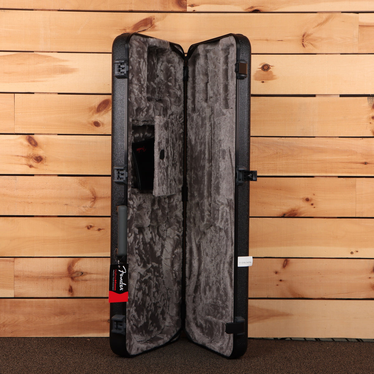 Fender American Professional Stratocaster hard-shell case open showing gray plush interior and black molded exterior