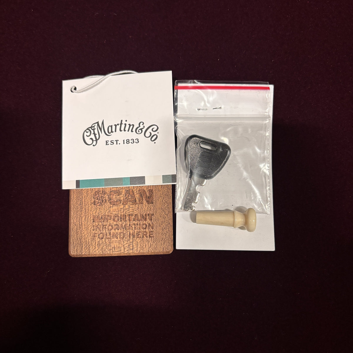 Martin D-41 Natural with Aging Toner acoustic guitar hang tag, case key, end pin, and wooden QR scan card accessories