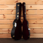 Martin CEO-7 acoustic guitar hardshell case open black exterior red velvet interior with gold hardware latches