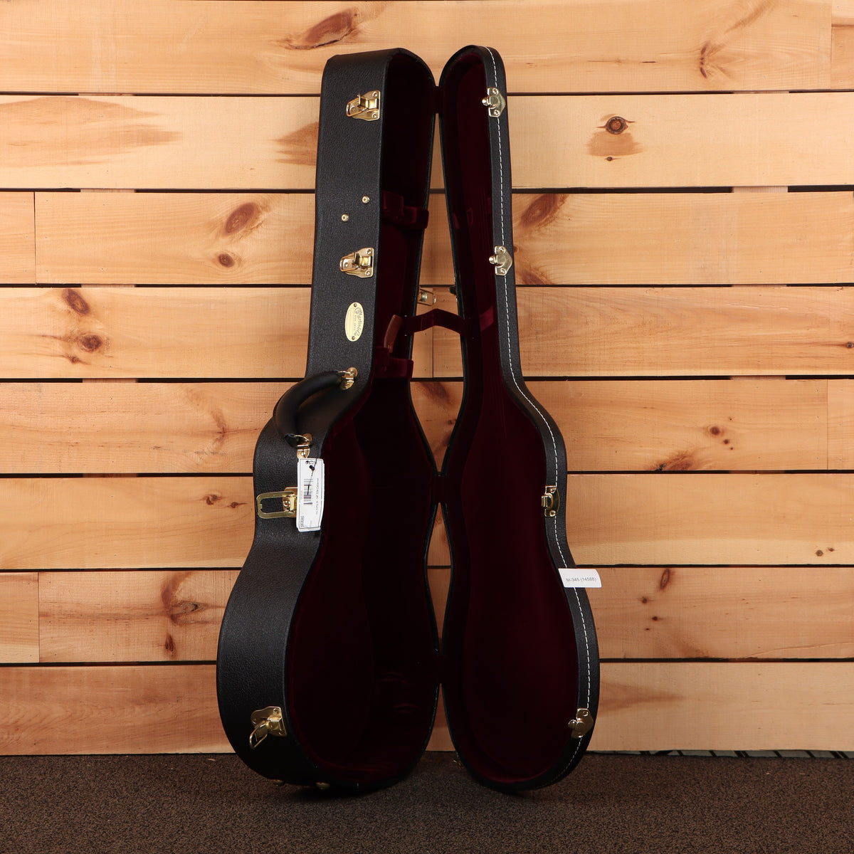 Martin CEO-7 acoustic guitar hardshell case open black exterior red velvet interior with gold hardware latches