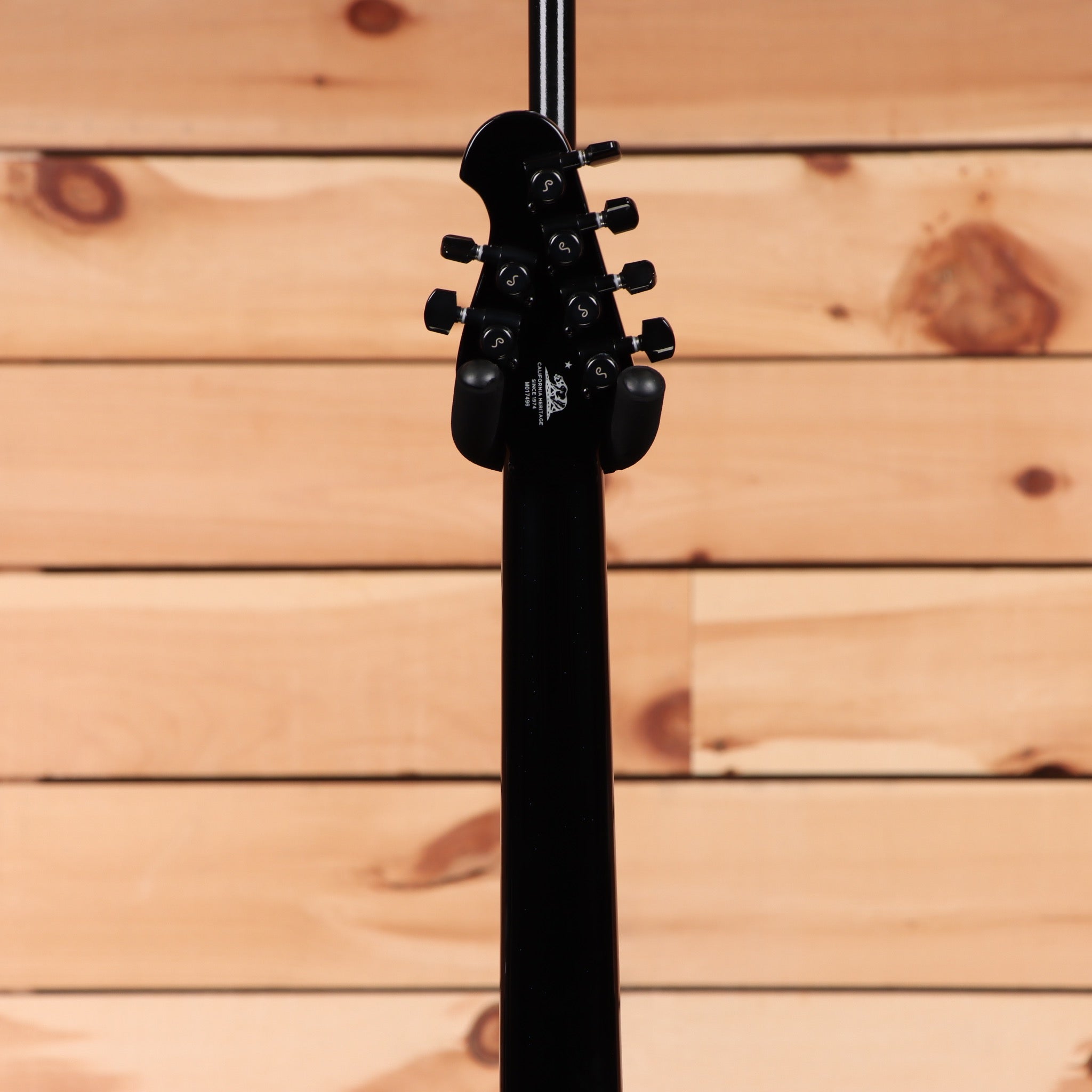 Ernie Ball Music Man Majesty 6 electric guitar Okelani Blue with black headstock tuning pegs