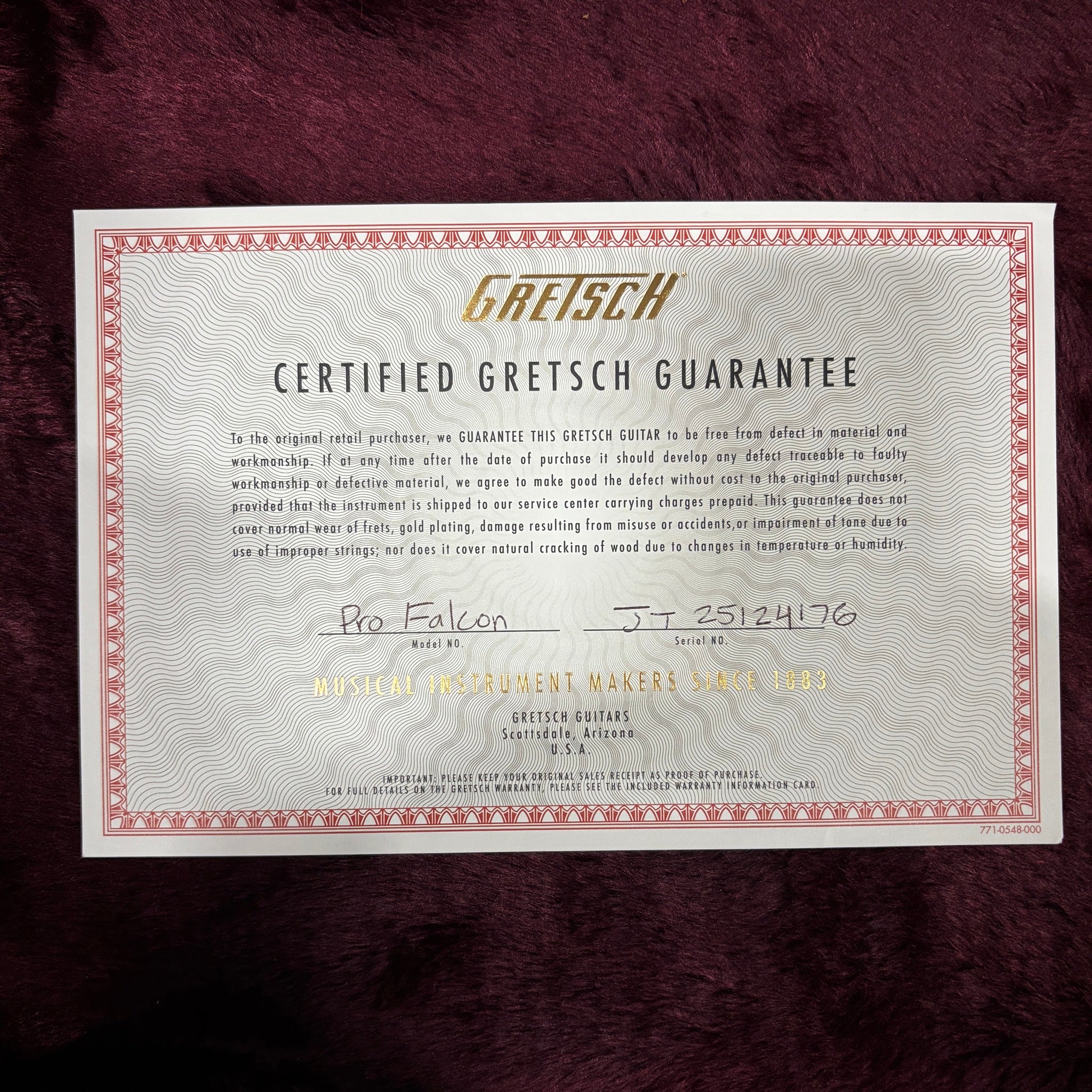Gretsch Pro Falcon Certified Guarantee warranty card with gold logo and handwritten serial number JT25124176
