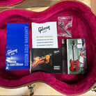 Gibson Derek Trucks SG Vintage Red hardshell case interior with owner's manual, warranty card, and accessories