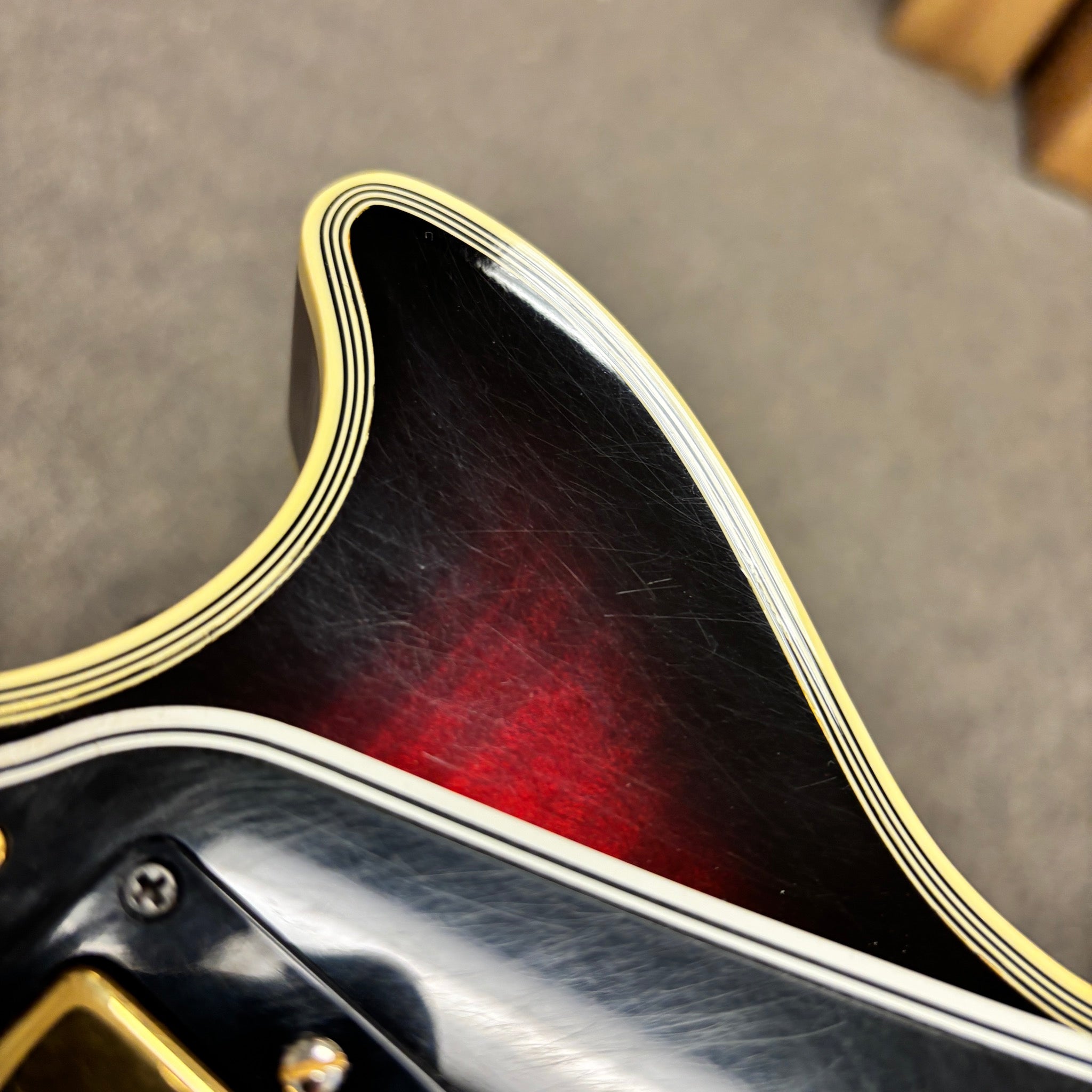 Gibson 68 Les Paul Custom Figured Tri-Burst electric guitar body cutaway detail with multi-ply cream binding and gold hardwar