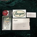 Bourgeois Downeast GAC Koa Natural guitar accessories bundle with certificate of authenticity, sticker, and D'Addario items