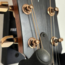 Taylor 724ce acoustic-electric guitar Natural finish close-up of headstock with gold tuning machines and walnut binding