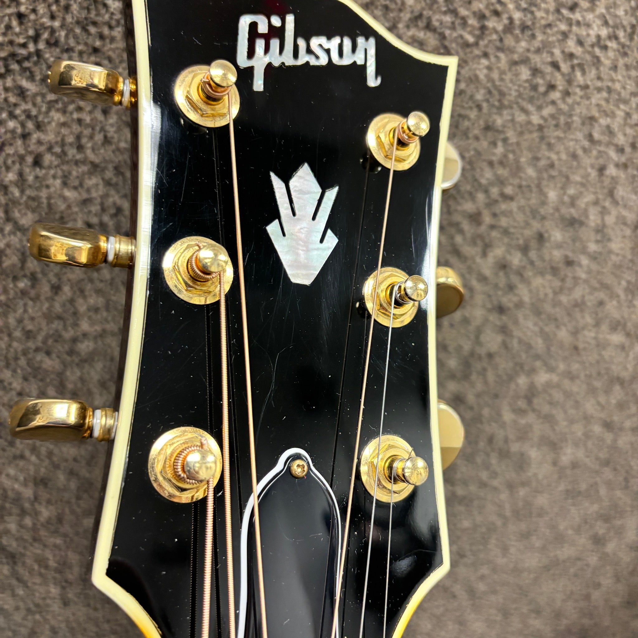 Gibson SJ-200 Standard Sunburst acoustic guitar headstock with gold tuners and mother-of-pearl crown inlay