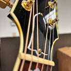 Gibson SJ-200 Standard acoustic guitar Sunburst closeup headstock with gold tuners and cream binding