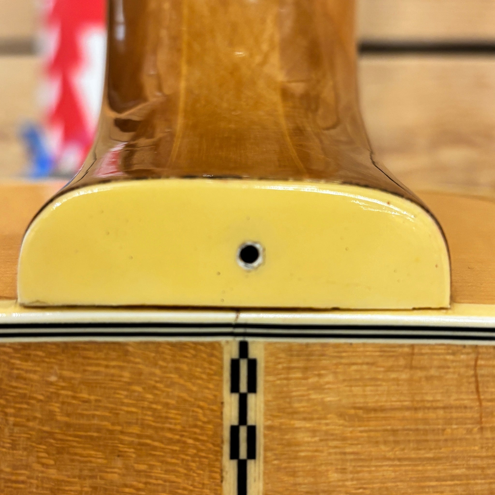 Epiphone FT-570BL acoustic guitar Natural finish close-up of neck heel joint with checkered inlay and cream binding