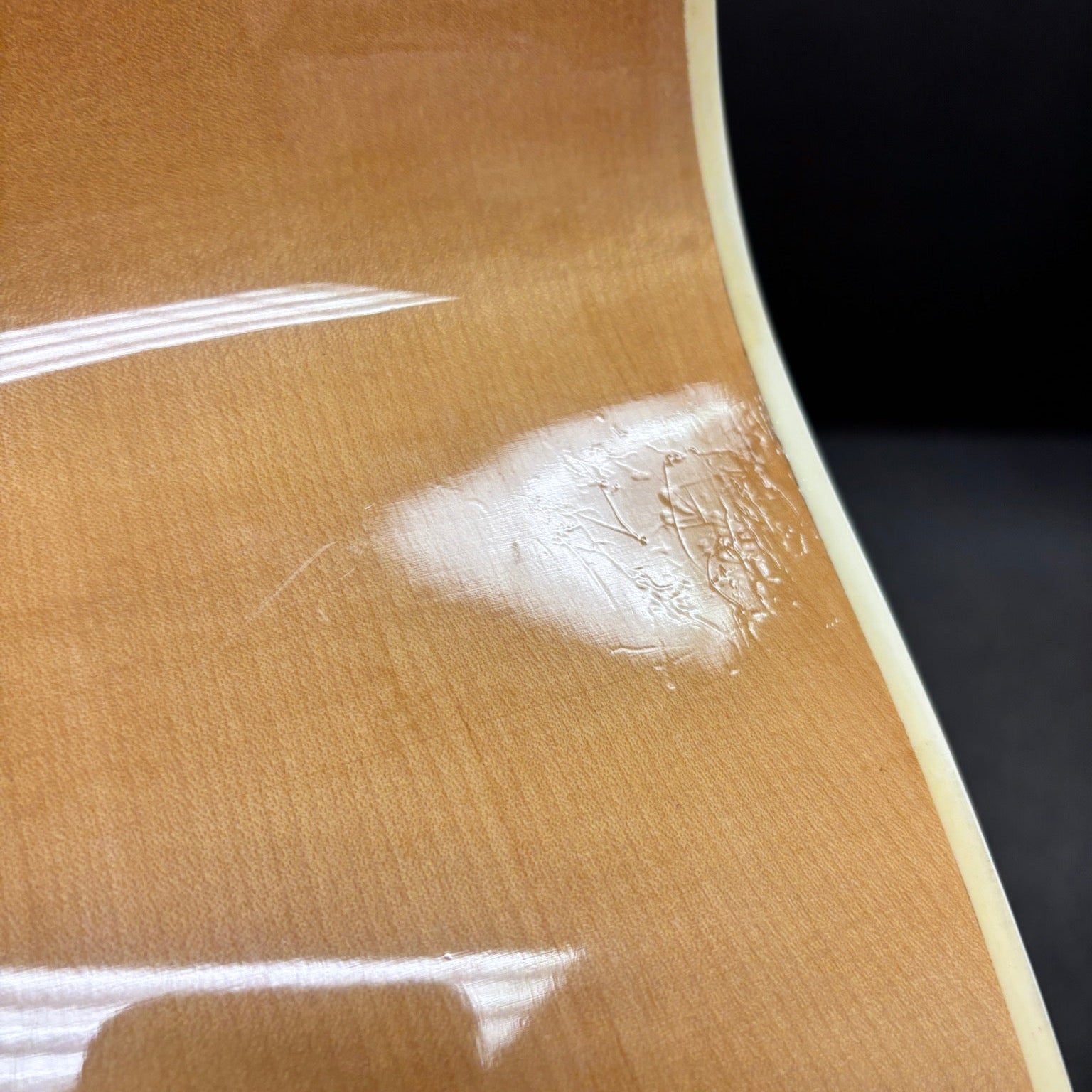Epiphone FT-570BL acoustic guitar Natural finish close-up showing body wear and finish damage with cream binding