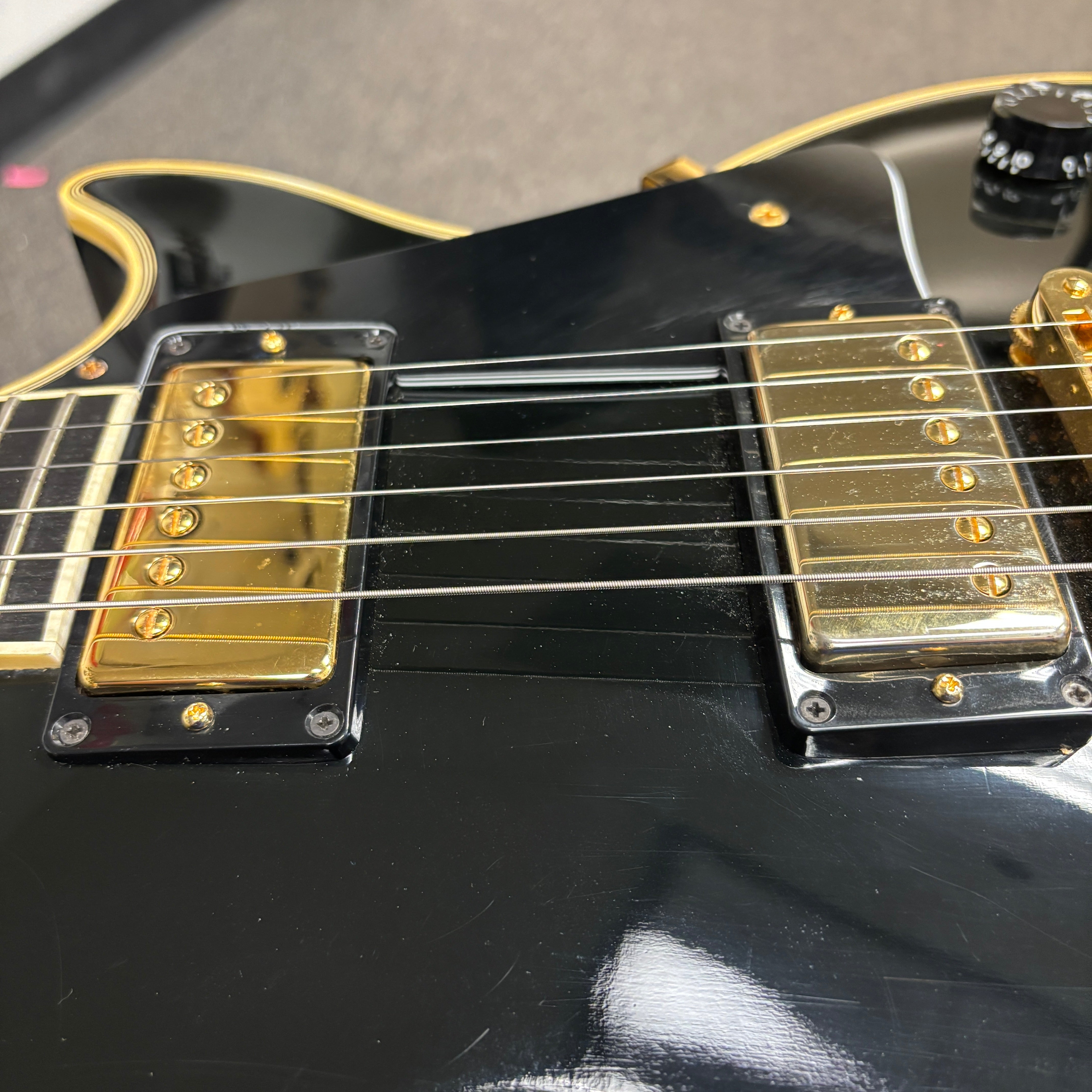 Pre-owned Gibson 1988 Les Paul Custom ebony electric guitar with gold humbucker pickups