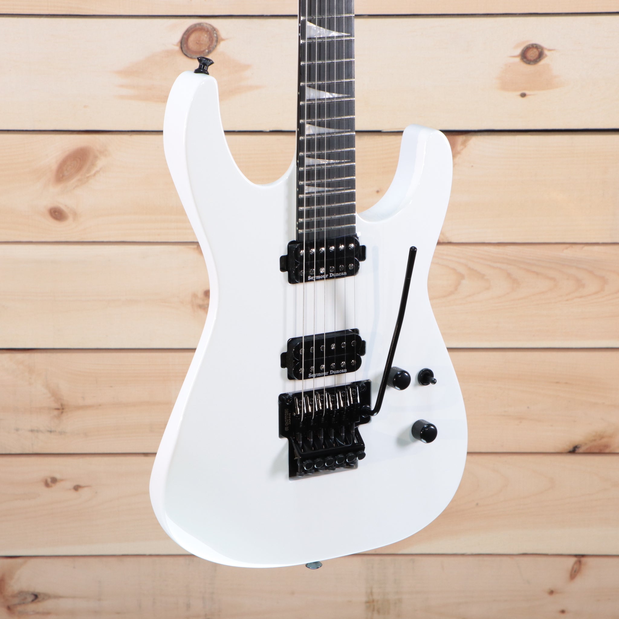 Jackson MJ Series Soloist SL2 electric guitar Snow White with black humbucker pickups and Floyd Rose tremolo