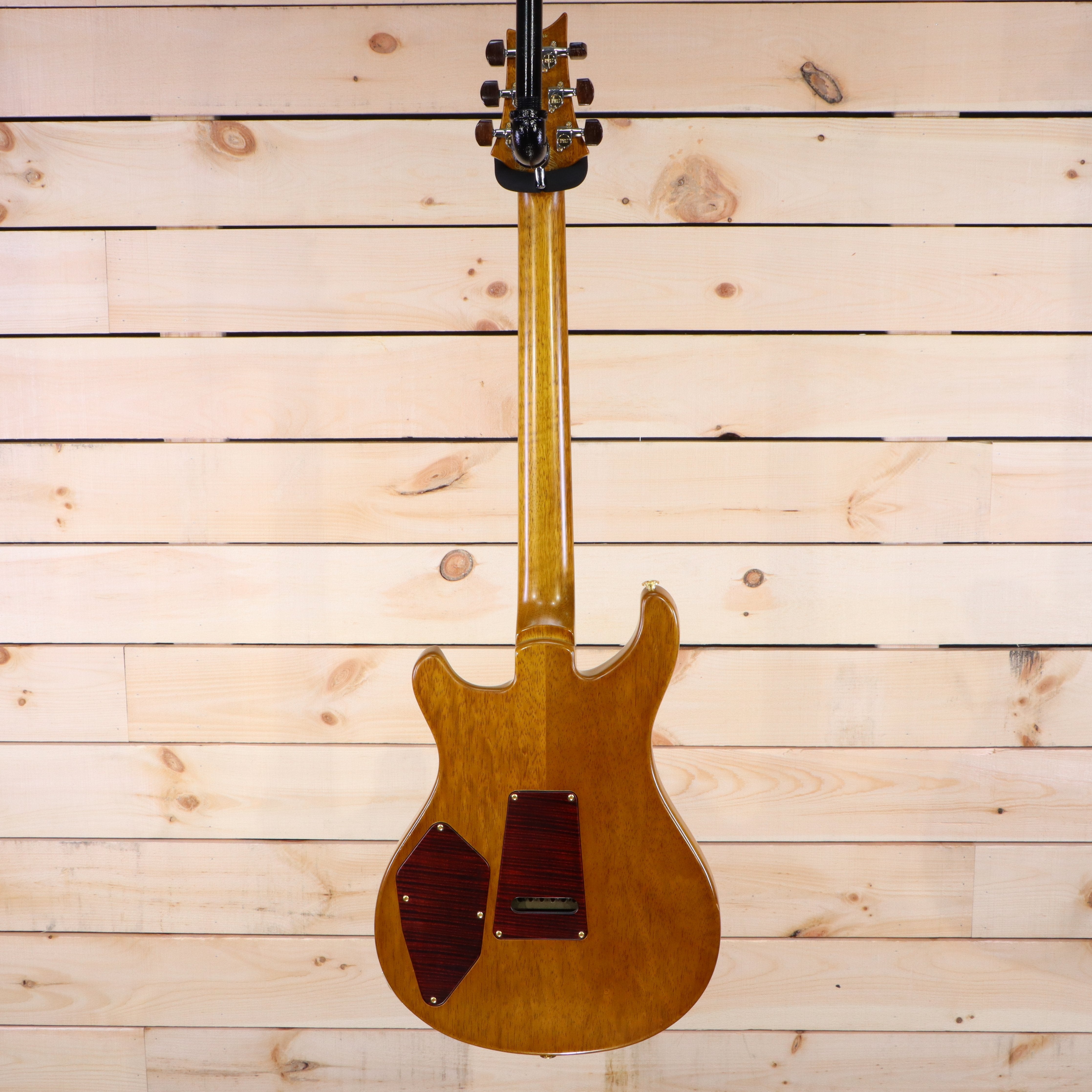 PRS Private Stock 513 electric guitar natural finish back view with decorative cavity covers and through-neck construction
