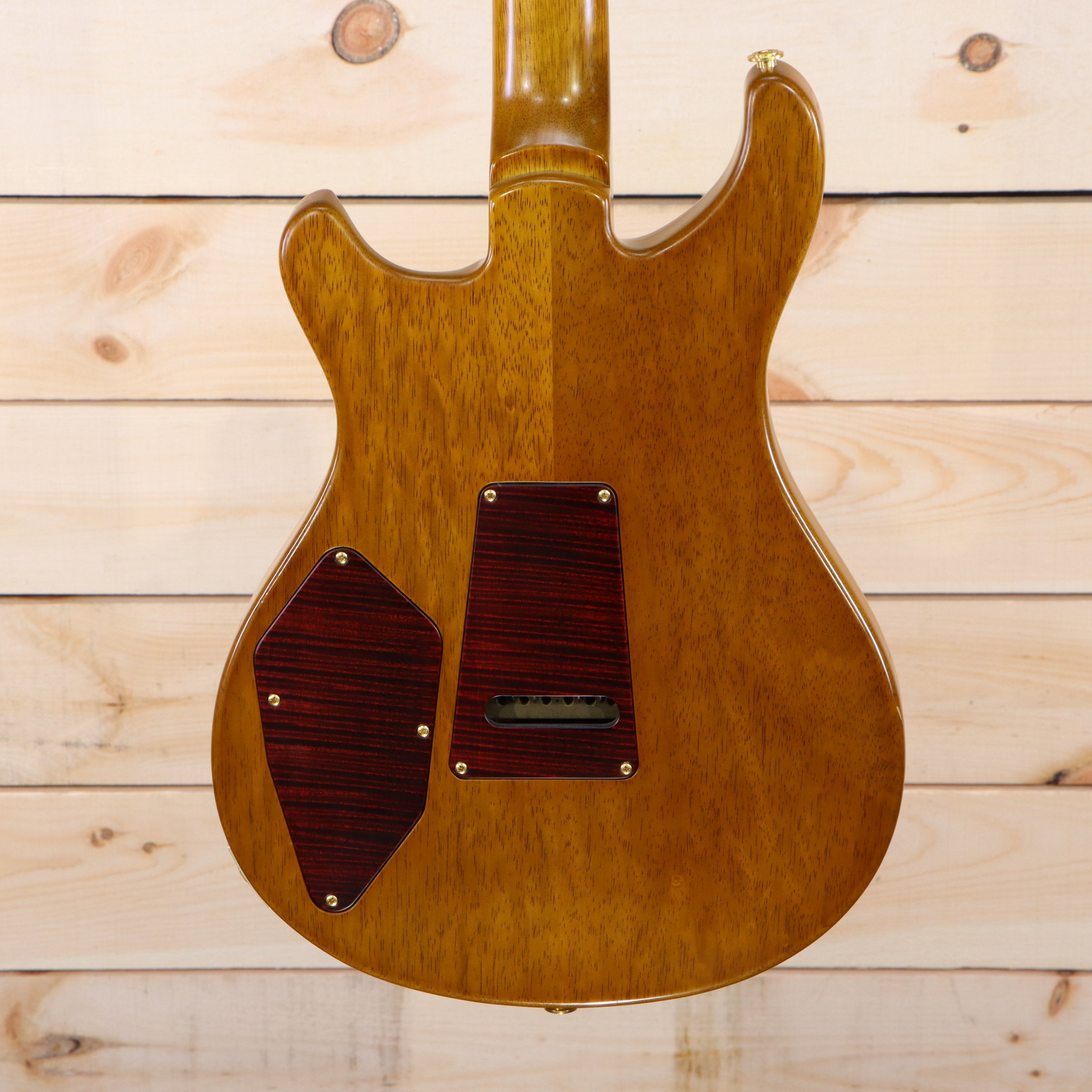 PRS Private Stock 513 electric guitar natural finish back view with dark wood control cavity covers and gold hardware
