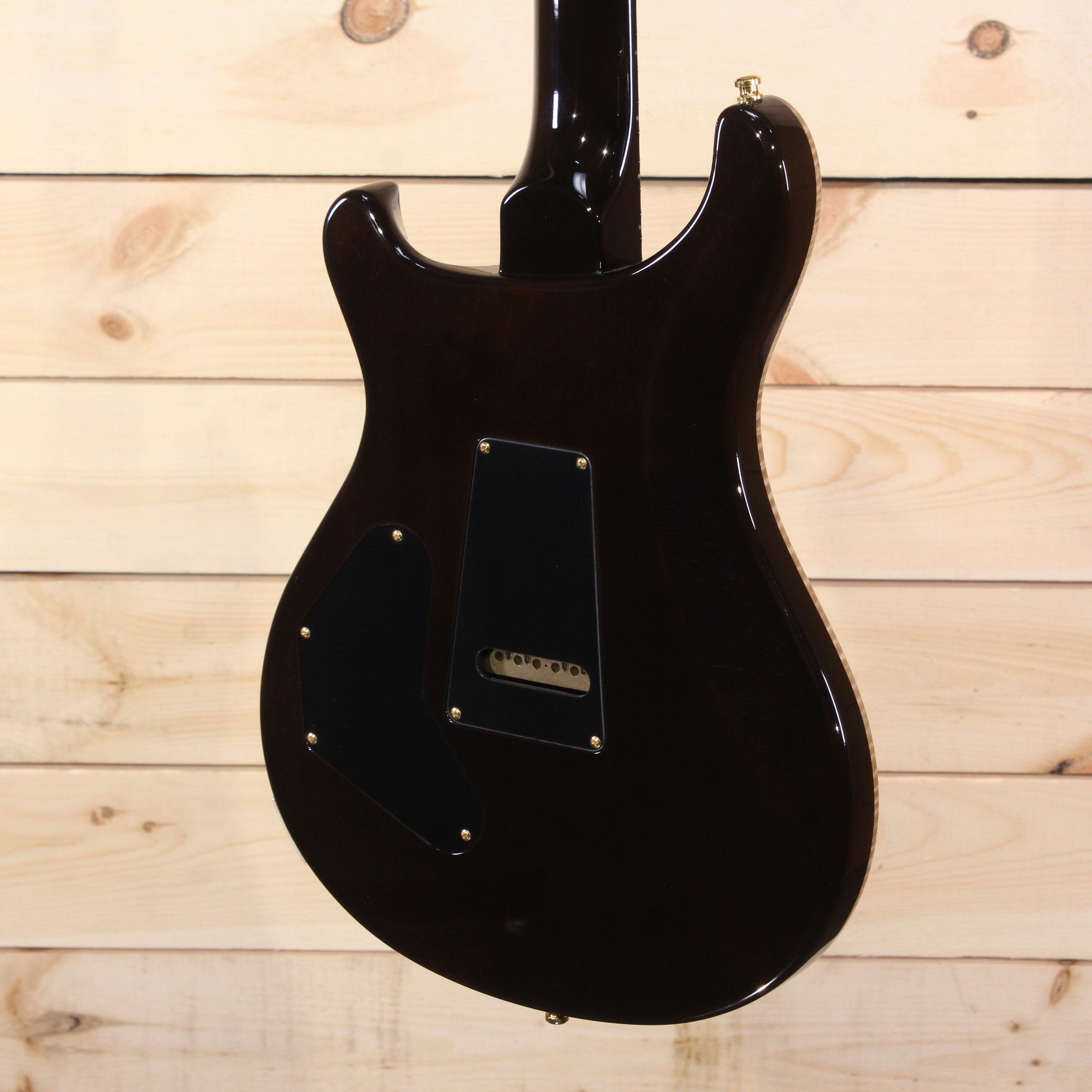 PRS Private Stock Custom 24 electric guitar black finish back view with gold hardware and tremolo cavity cover