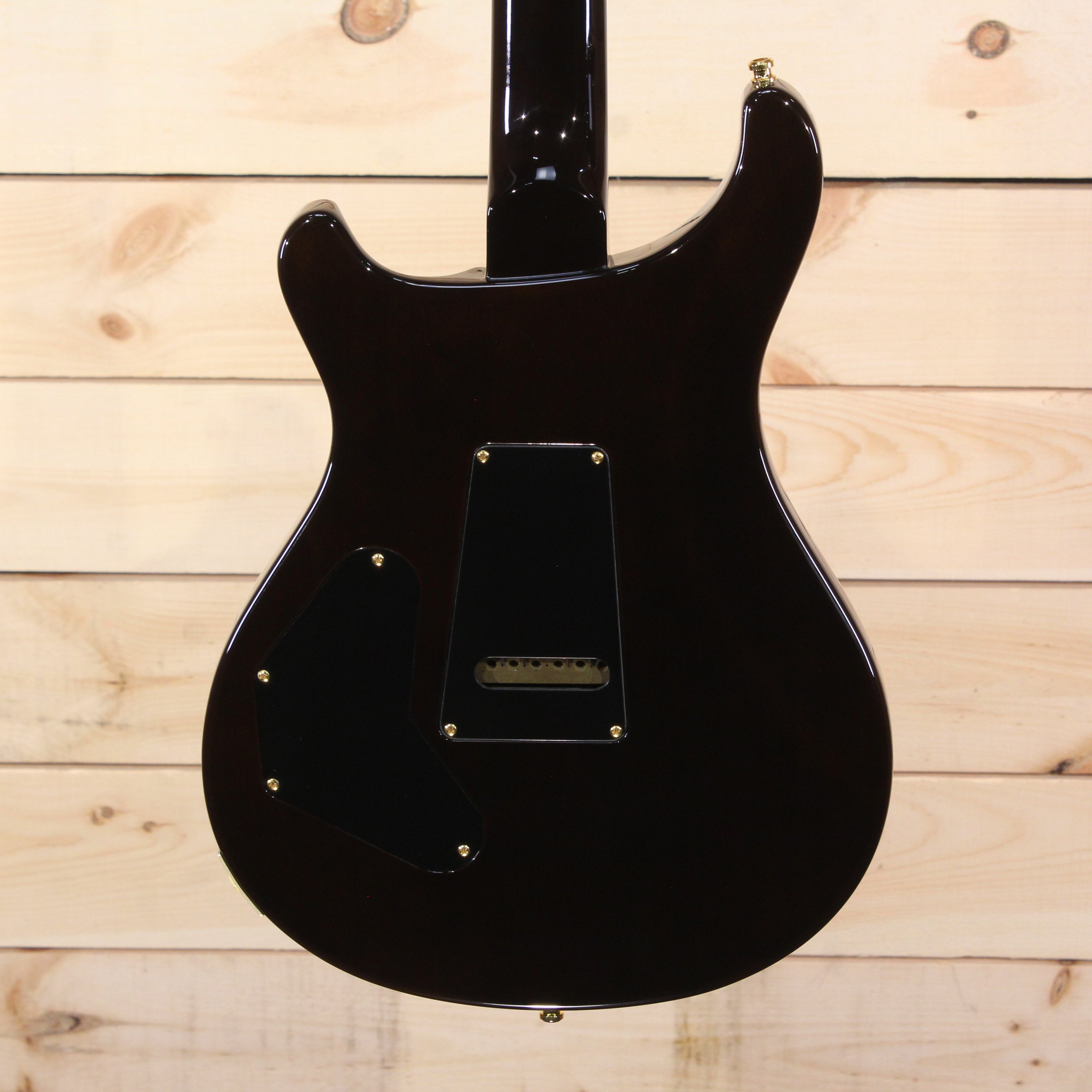 PRS Private Stock Custom 24 electric guitar black gloss finish back view with gold hardware and tremolo cavity cover