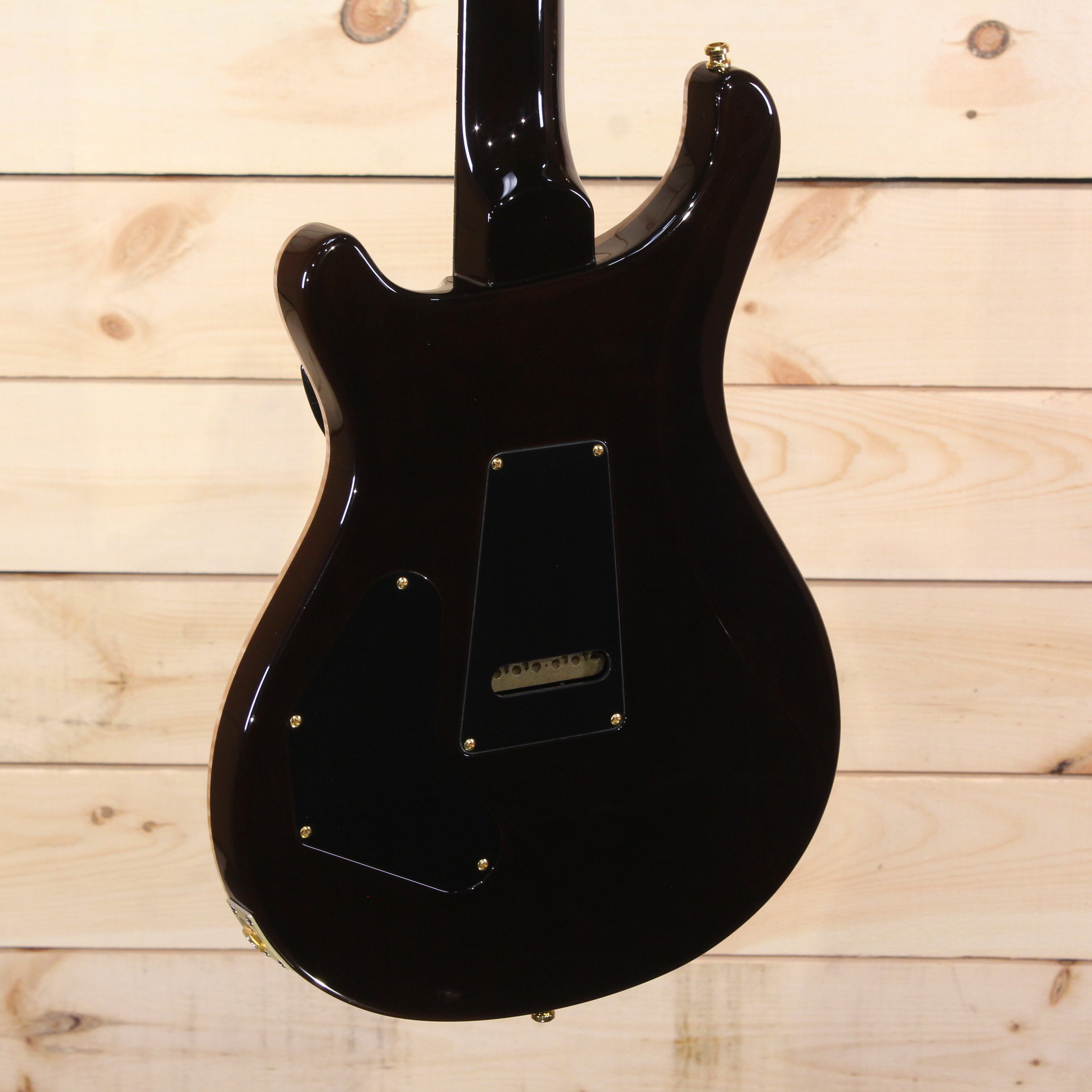 PRS Private Stock Custom 24 electric guitar black finish back view with gold hardware and control cavity covers