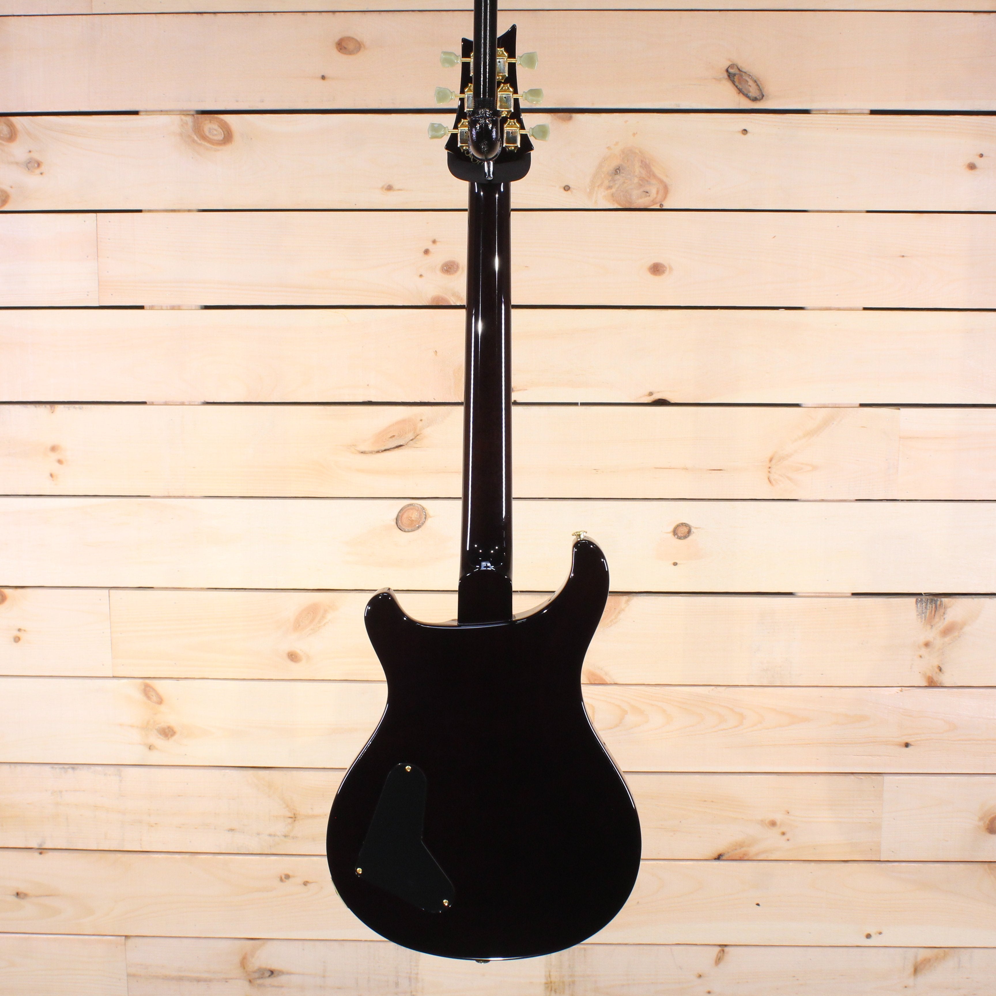 PRS Private Stock McCarty electric guitar black finish back view with gold hardware and contoured mahogany body