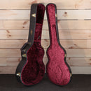 Taylor 224ce-K DLX acoustic-electric guitar hard case open showing burgundy velvet interior with gold hardware latches