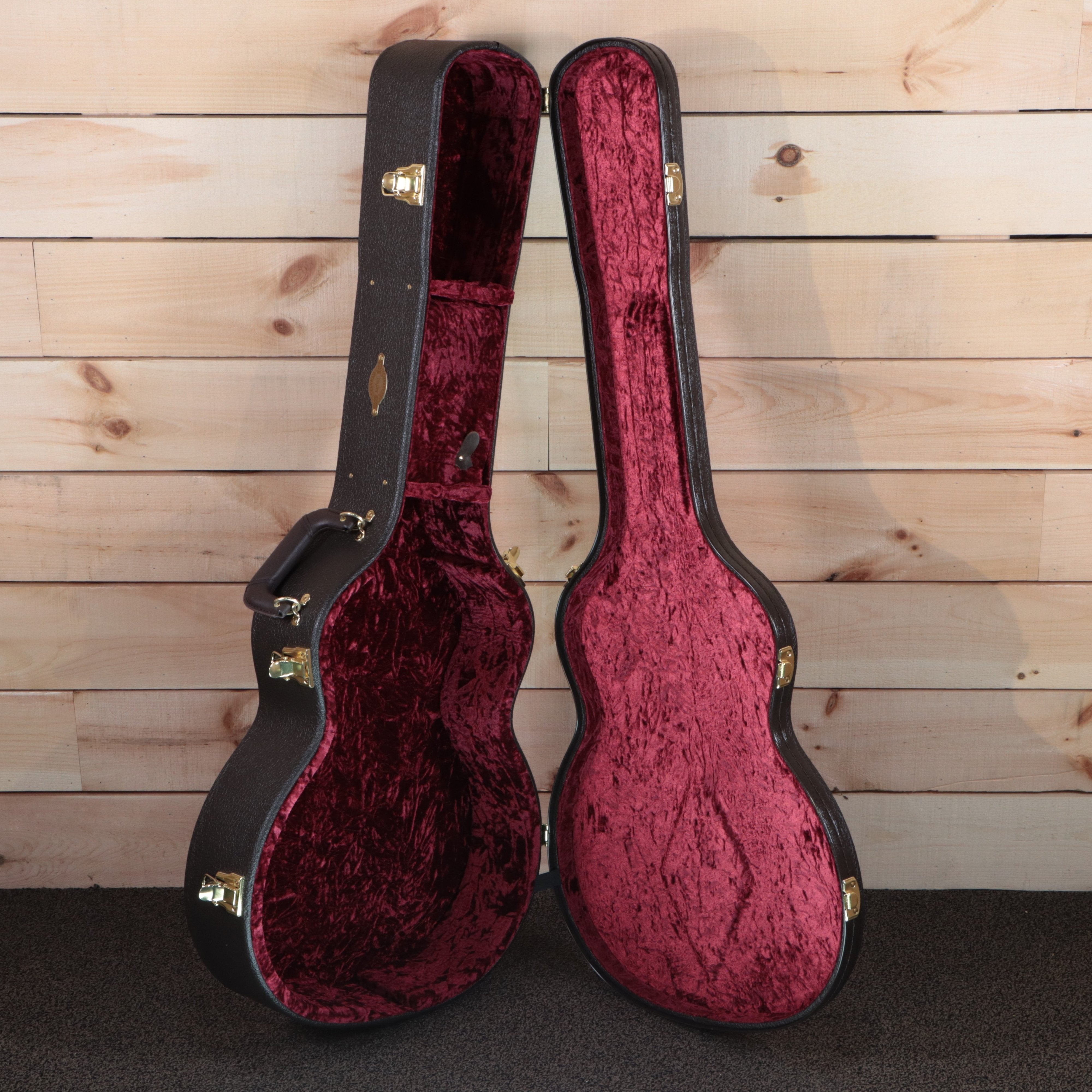 Taylor 224ce-K DLX acoustic-electric guitar hard case open showing burgundy velvet interior with gold hardware latches