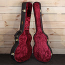 Taylor 614ce Builder's Edition acoustic-electric guitar case open showing red velvet interior with gold hardware latches