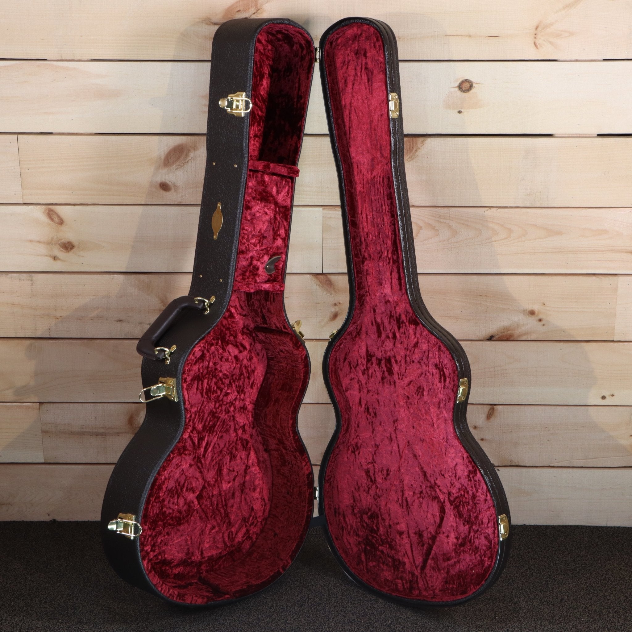 Taylor 614ce Builder's Edition acoustic-electric guitar case open showing red velvet interior with gold hardware latches