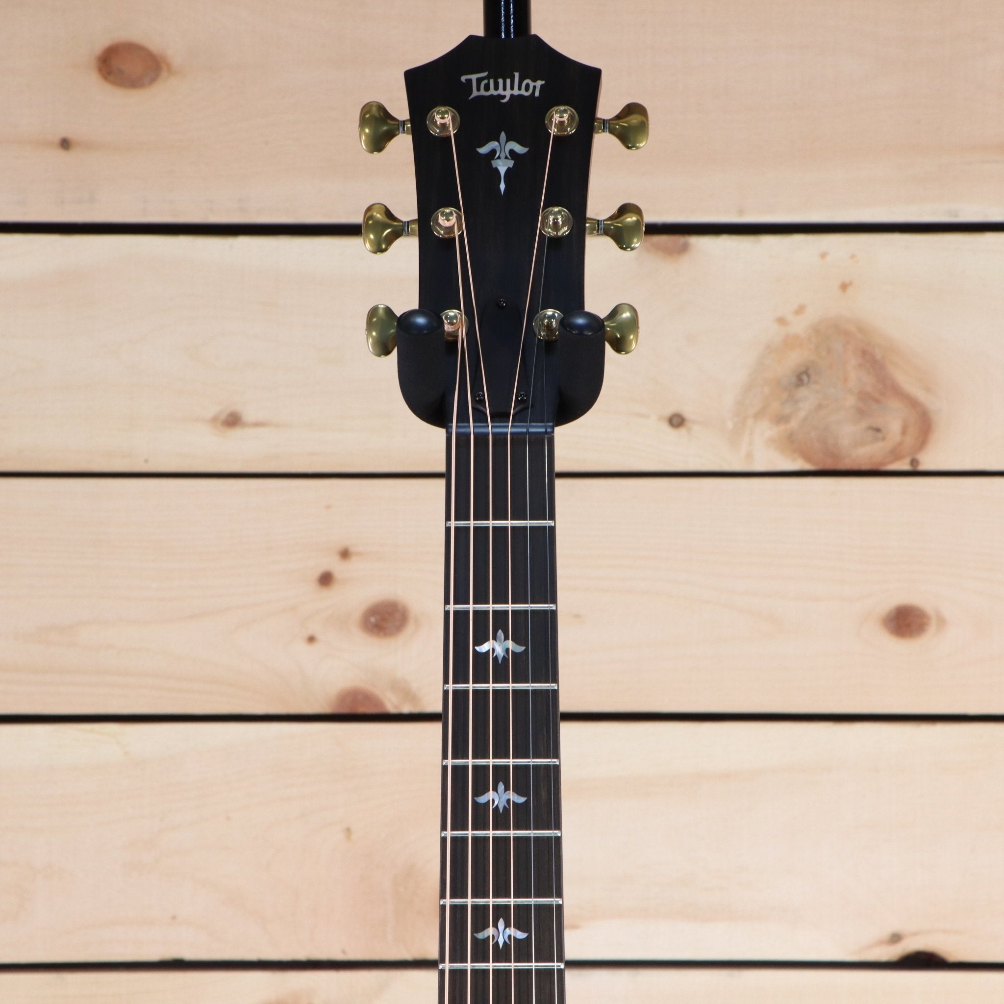 Taylor 614ce Builder's Edition acoustic-electric guitar headstock with gold tuners and fleur-de-lis fretboard inlays