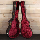 Taylor 818e acoustic-electric guitar hardshell case open showing red crushed velvet interior with gold hardware latches