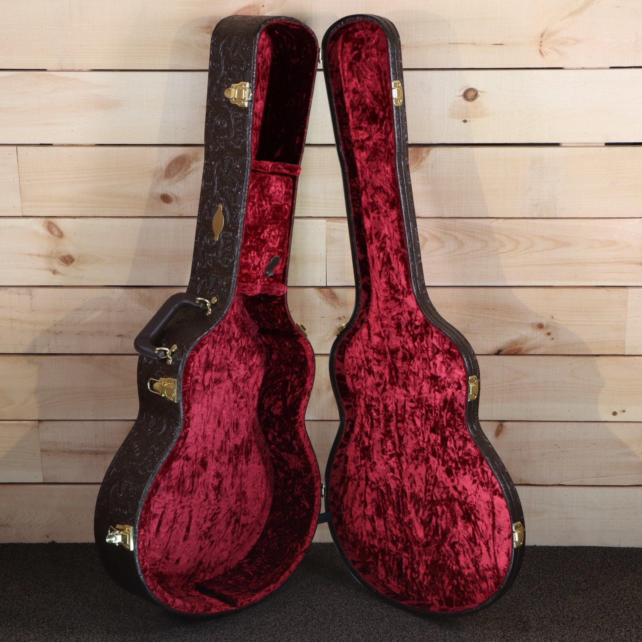 Taylor 818e acoustic-electric guitar hardshell case open showing red crushed velvet interior with gold hardware latches