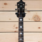 Taylor 818e Grand Orchestra acoustic-electric guitar headstock with ebony fretboard and mother-of-pearl inlays