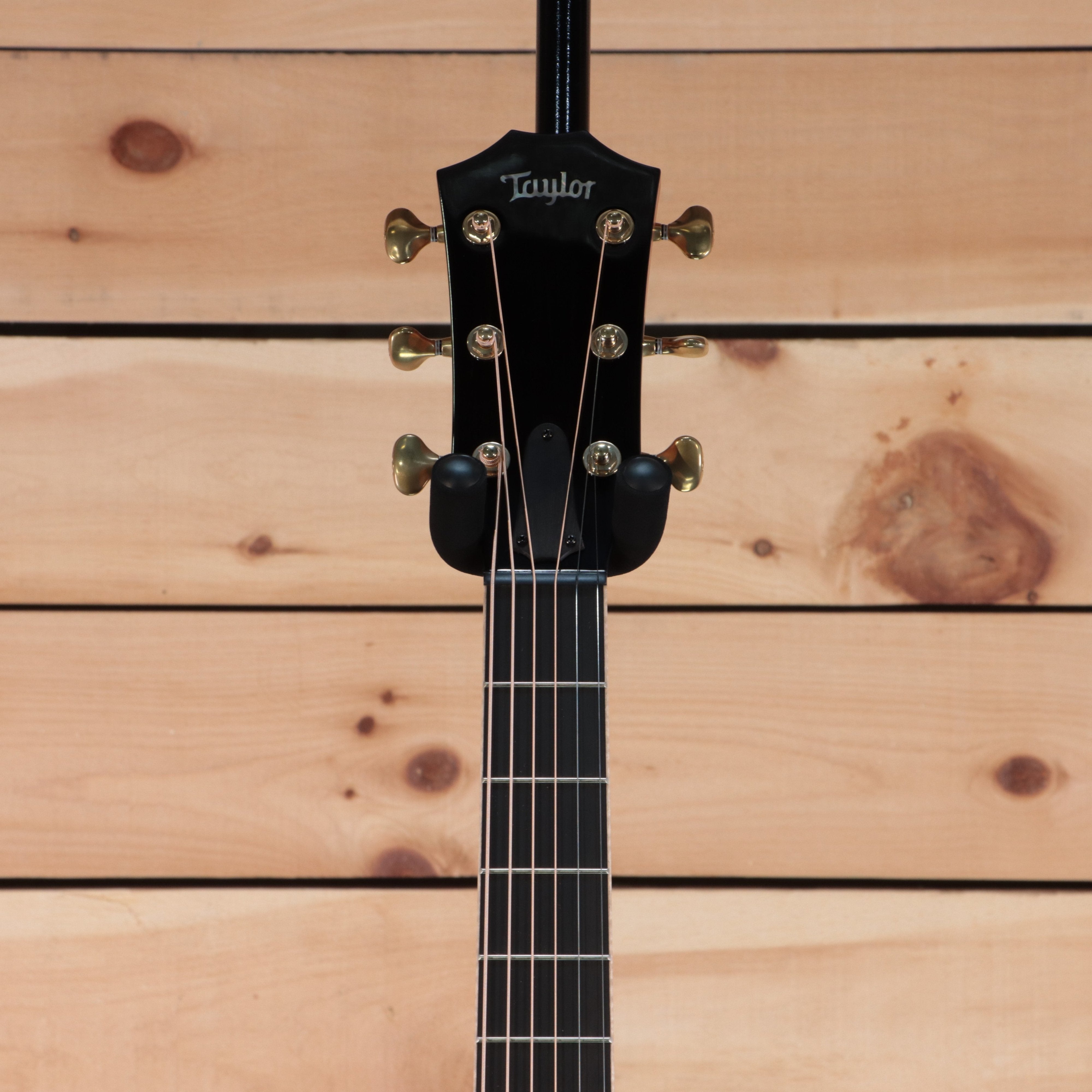 Taylor 2022 Custom GA acoustic guitar black finish with gold tuners and ebony fretboard headstock view