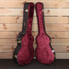 Taylor K14ce Builder's Edition acoustic guitar hardshell case open showing burgundy velvet interior gold hardware