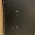 Warrior The Passion W-001 electric guitar back view showing black finish with visible wear and scratches